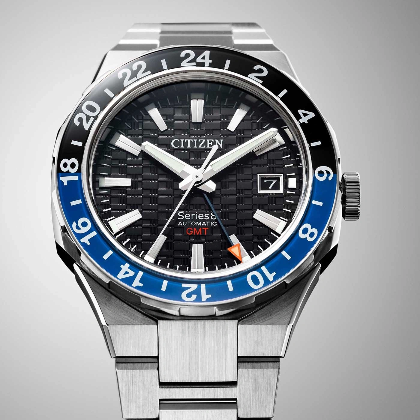 Citizen Series 8 GMT watch with black and blue bezel, date display.