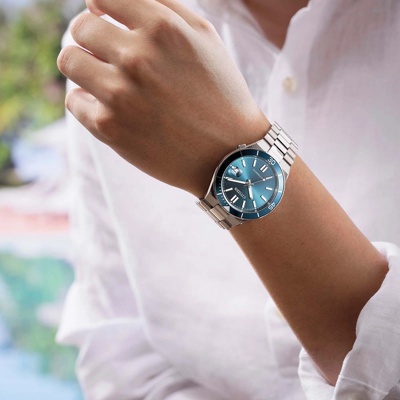 Un homme porte une montre Citizen bleue sur son poignet.