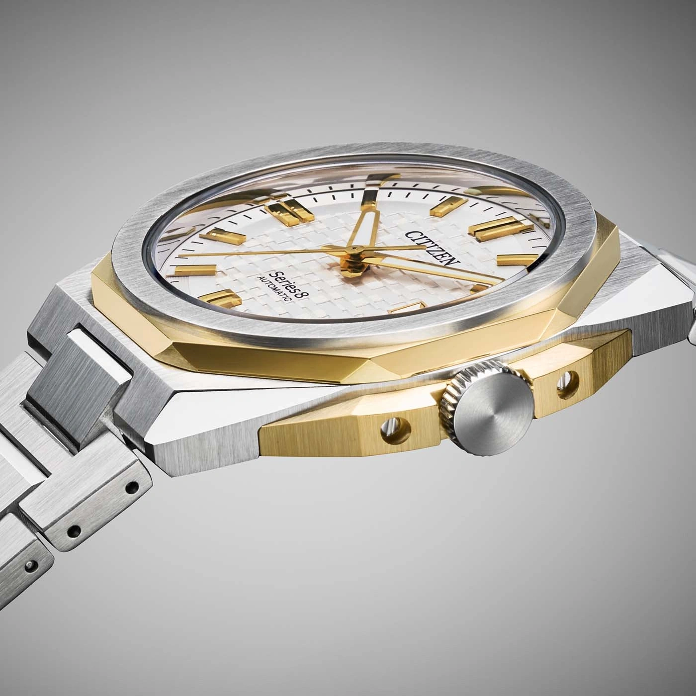 Montre Citizen dorée et argentée avec bracelet métallique.