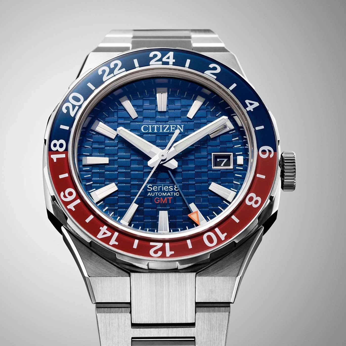 Citizen watch with blue and red bezel, GMT function, and date display.