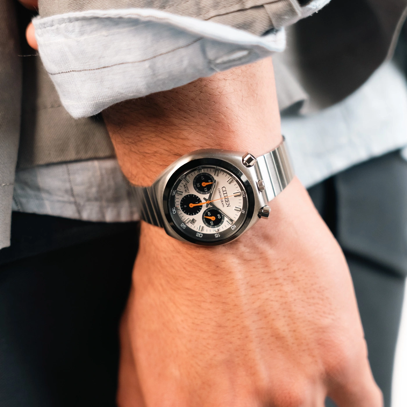 Homme portant une montre Citizen Chronograph argentée avec bracelet métallique.